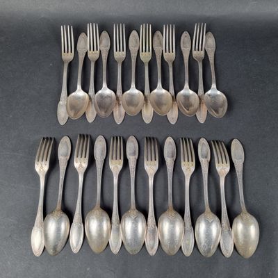 six forks and six spoons are lined up on a table