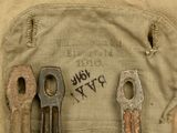 two old tools in a canvas pouch on a table