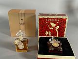 a small box with a perfume bottle in it and a small box with a perfume bottle in it