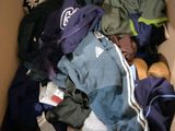 a box full of clothes that is sitting on the floor