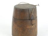 a small wooden box with a handle on a white surface