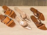 three pairs of women ' s sandals on a wooden surface