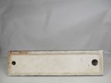a close up of a white metal object on a table