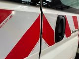 a red and white stripe on the side of a train
