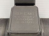 a close up of a metal object on a white surface