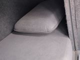a bed in the back of a car with two pillows