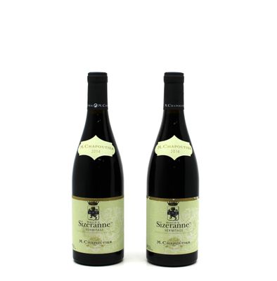 two bottles of wine sitting next to each other on a white surface