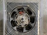 a fan that is sitting inside of a metal cage