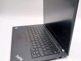 a laptop that is open on a white surface