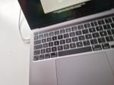 a laptop computer sitting on top of a white table