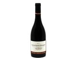 a bottle of wine sitting on top of a white table