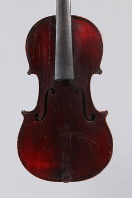 an old violin with a bow hanging from it ' s back