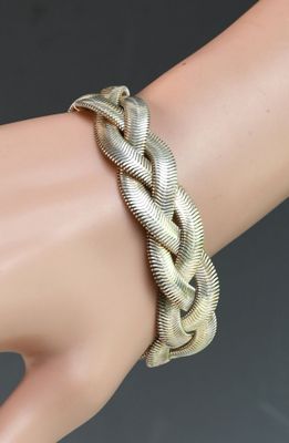 silver plated bracelet with a braid design on a mannequin hand
