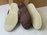 three pairs of shoes are lined up on a white surface