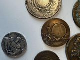 a lot of coins that are on a white surface