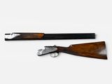 a pair of shotguns sitting on top of a white surface
