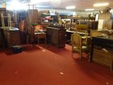 a room filled with lots of furniture and a red carpet