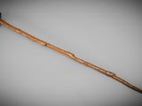 an old wooden walking stick with a wooden handle on a gray background