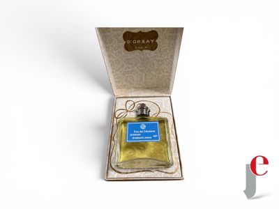 an open box with a bottle of perfume in it on a white surface