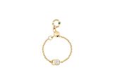 un bracelet en chaîne d'or orné d'une perle en cristal verte et blanche