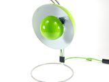 a green and white lamp that is connected to a wire