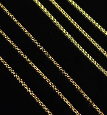 a close up of a row of gold chains on a black background