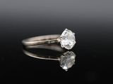 a close up of a diamond ring on a black surface