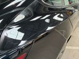 a black car parked on the side of the street