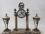 a picture of a clock and three vases sitting on a table