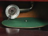 an old record player sitting on top of a wooden table