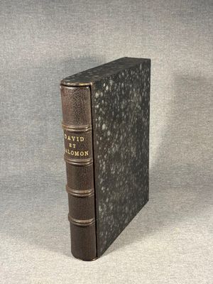 an old book sitting on top of a table next to a gray background