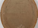 an old wooden plate sitting on top of a white pedestal