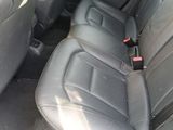 a seat belt in the back of a car with a bottle in it