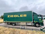 a green truck that is parked on the side of the road