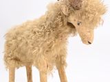 a stuffed animal that is standing on a white surface