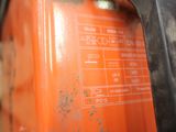 a close up of an orange gas can with a label on it