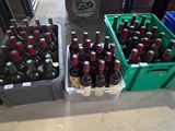 many bottles of beer sitting on a table in a store