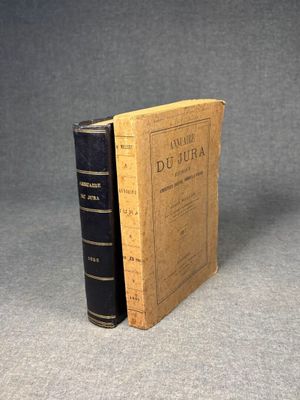 an old book sitting on top of a table next to a book
