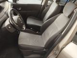the interior of a car with a steering wheel and seat covers