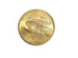 a close up of a gold coin on a white surface