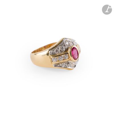 a close up of a gold ring with a ruby stone