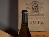 a bottle of wine sitting on a table next to a box of wine