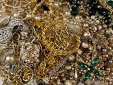a pile of jewelry that is laying on a table