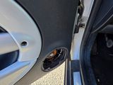 a close up of a car door handle with a hole in it