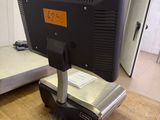 a computer monitor sitting on top of a wooden table