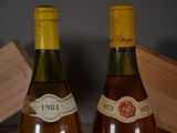 two bottles of wine sitting on a table next to each other