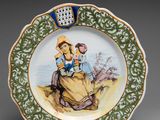 un gros plan d'une assiette sur laquelle figurent une femme et un enfant