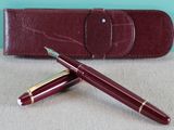 a pen and a case sitting on a table