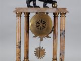 a clock that has a lion on top of it