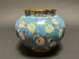 an image of a blue vase with flowers on it sitting on a table